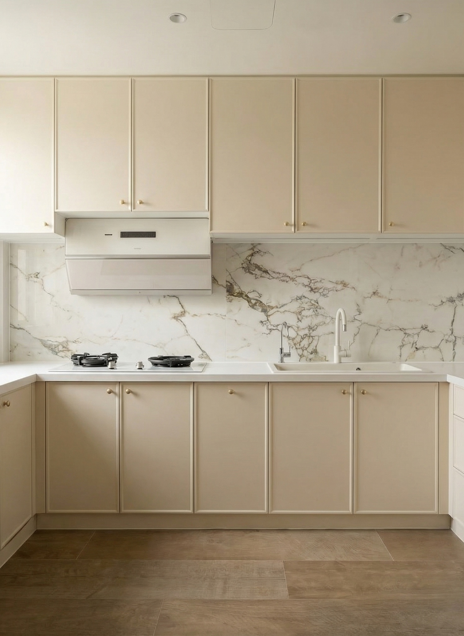 Kitchen with cream cabinetry, brass knobs and a white marble backsplash